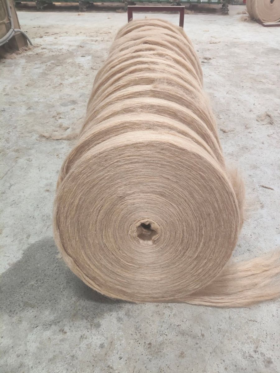 Large roll of golden jute sliver on the mill floor